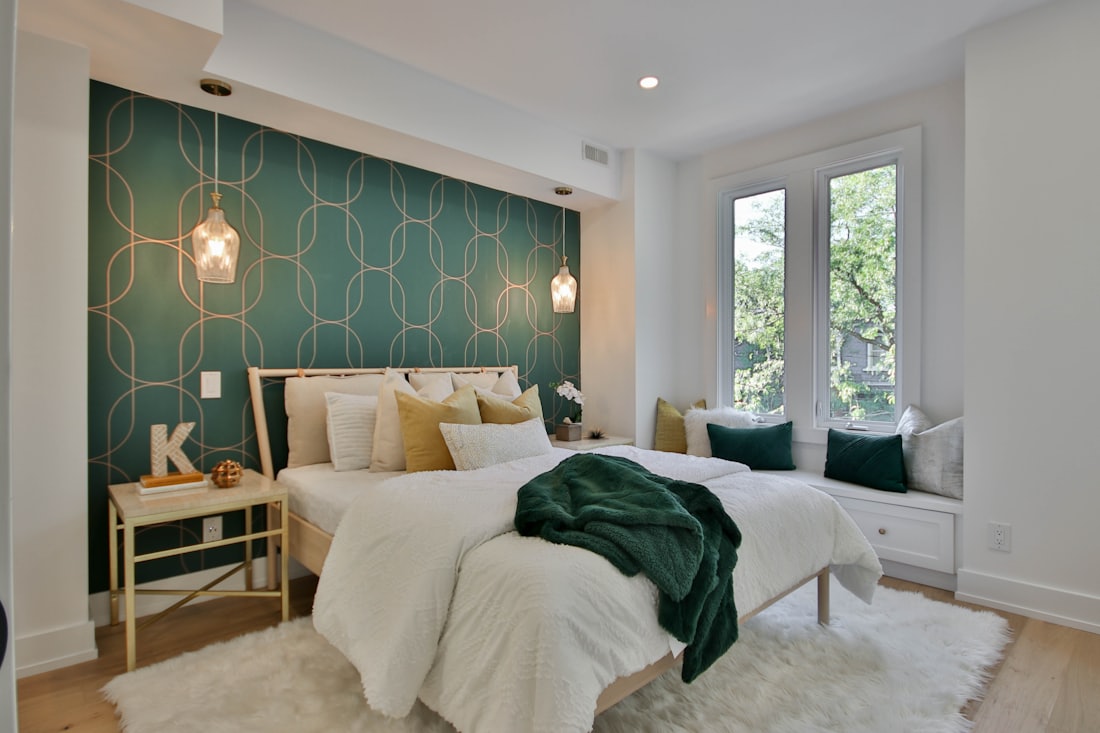 Bedroom with a deep green accent wall