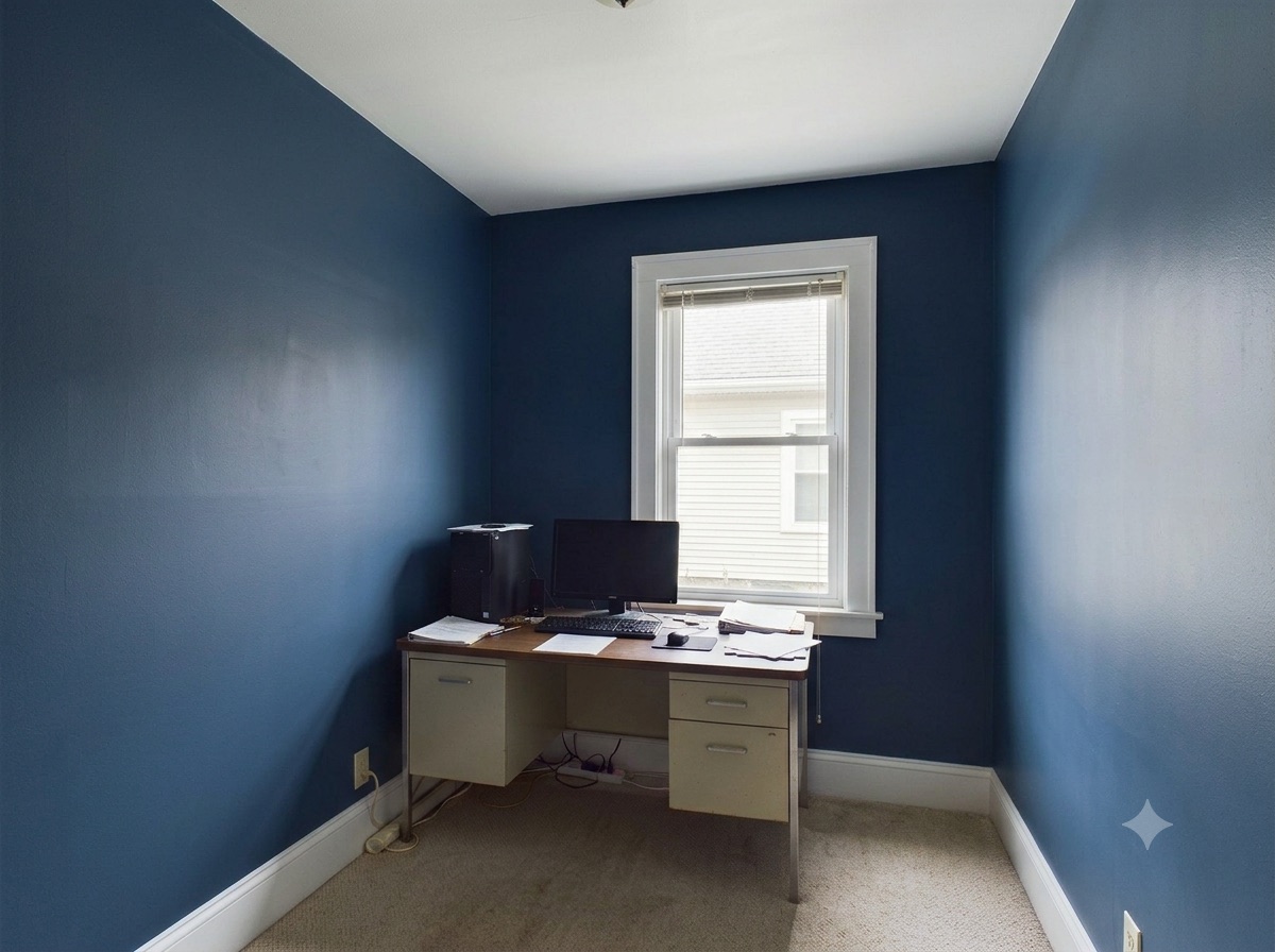 Same home office after painting — deep navy accent walls with white trim