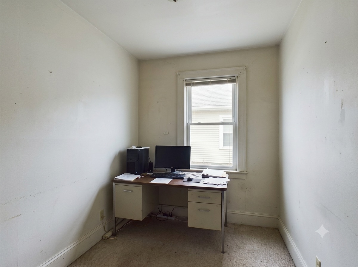 Home office before painting — worn off-white walls